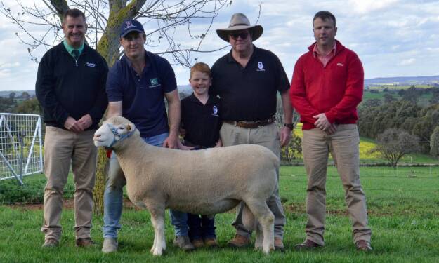 The $18,000 top-priced ram with auctioneer Rick Power, Nutrien stud stock, James Corcoran Jnr, Gooramma stud, Galong, and buyers Billy, 7, Grahame and James Sharpe, Amelie Poll Dorsets, Uralla.