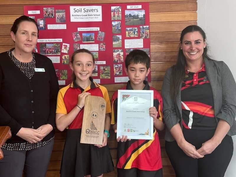 A Bakers Creek State School staff member, Amber Barnes, Solomon Davidson and teaching principal with their Landcare Award. Picture: Supplied