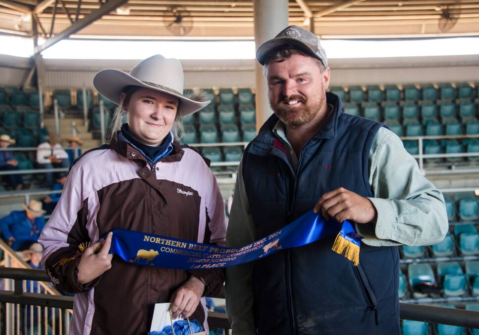 Charlotte Coggan, Columba Catholic College, and judge Kenneth Coleman with Charlotte's winning sash for the 14 years and over division in the Junior Schools Judging competition. Picture: Esp Family Photography 