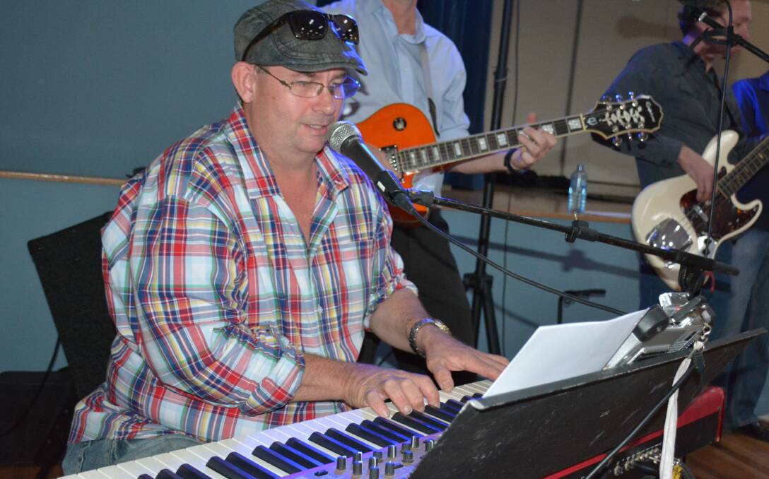 ACROSS THE REGION: David Whitehead performs with Off The Cuff in Julia Creek recently to celebrate the shire hall's upgrades. Photo: Chris Burns. 