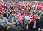Korean citizens protesting in the 2000s against US beef imports, which could be infected with mad cow disease. Japan had already banned US imports. Picture via Shutterstock.
