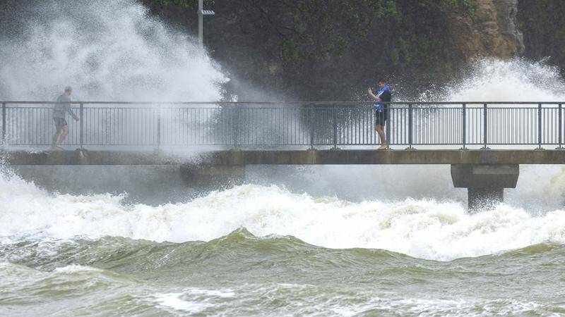 New Zealand is copping the brunt of a weakening cyclone today, as another weather system develops in the Gulf of Carpentaria to threaten the north. (AP PHOTO)