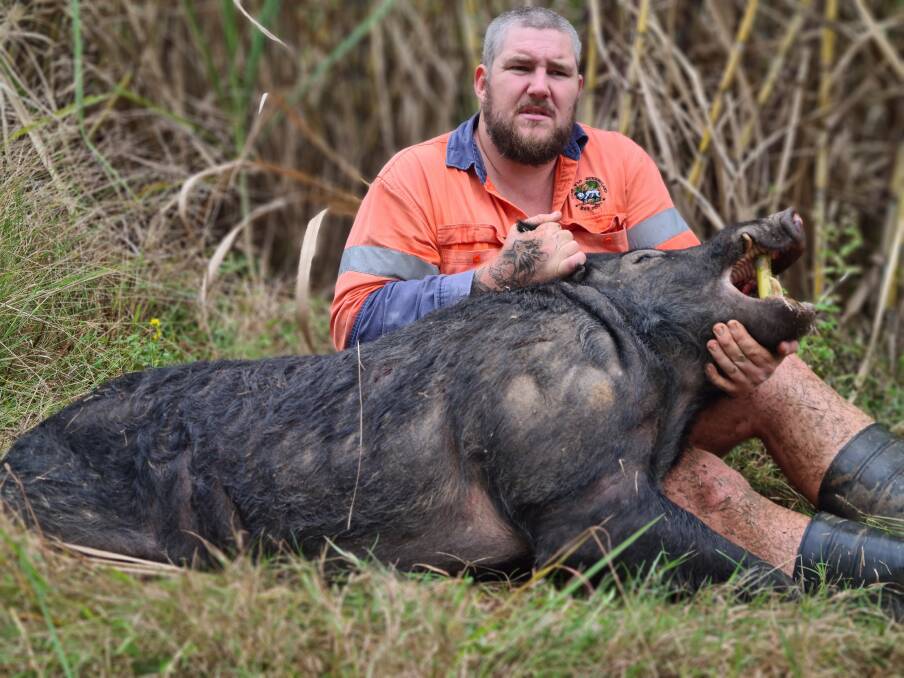Sam Floss and one of the many feral pigs he's culled recently.