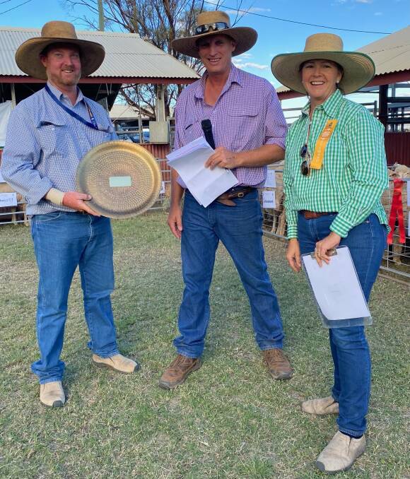 Judge Dan Burton, centre, presents Joe Taylor and Anita Dennis with their trophy for grand champion pen of goats at the Blackall Show. Picture: Sarah Pearson