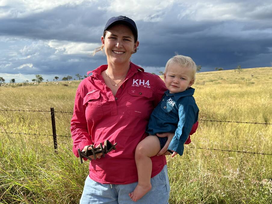Shannon Malone with her son Teddy, 1, holding their family's 149-year-old cattle brand KH4 on their property. Picture supplied 