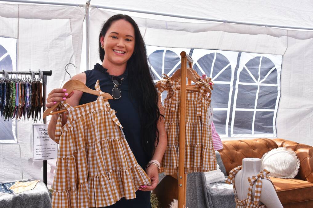 Keri holding one of her handmade garments at her pop up store in Charters Towers in early June. Picure: Ben Harden 