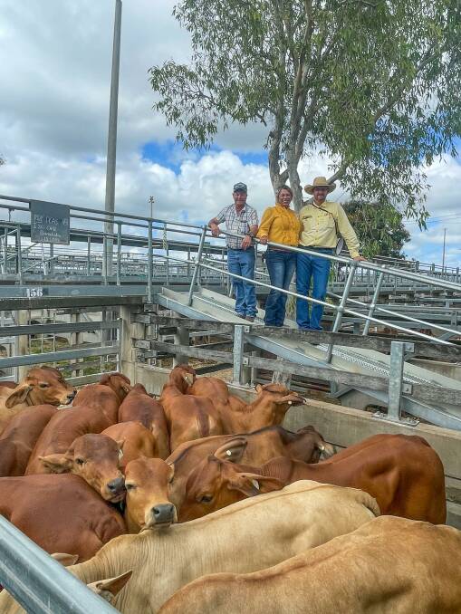 Gary Wendt of Ray White Rural, Gracemere, with vendors Ian and Gina Ohl of Olenga, Baralaba, who offered a run of Brangus Brahman cross steers for 458.2c/kg at the CQLX Gracemere cattle sale on Wednesday. Picture: Ben Harden