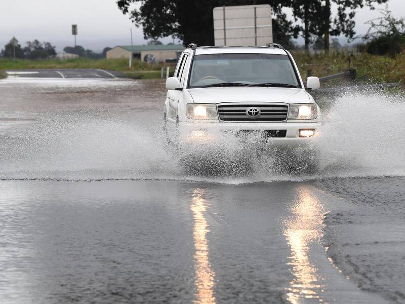 Motorists are being urged to stay clear of floodwater as north Queensland is battered by rain. (Darren England/AAP PHOTOS)