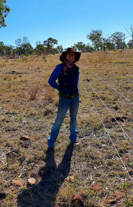 Amelia Downs grazier Jane Weir with her newly erected fence.
