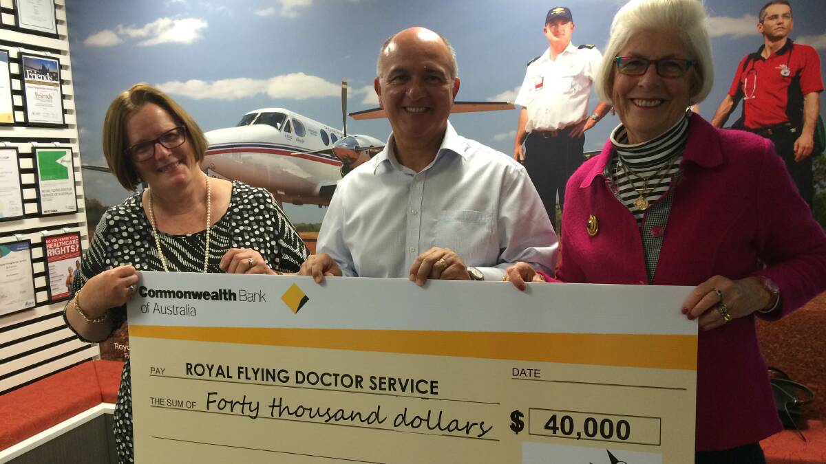 BIG CHEQUE: RFDS chief executive officer Nino Di Marco receives a cheque for $40,000 from Mary Woods and Liz Wood from Tie Up The Black Dog.